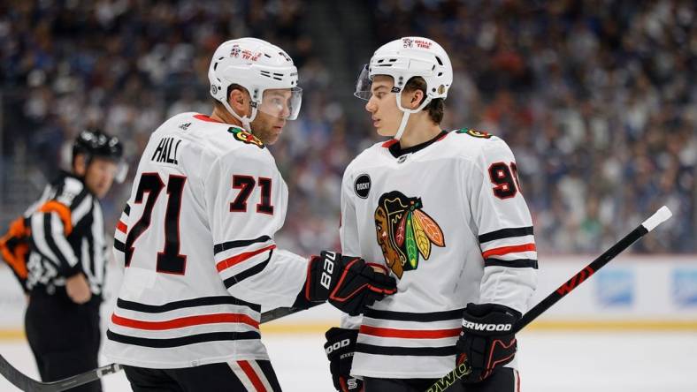 Oct 19, 2023; Denver, Colorado, USA; Chicago Blackhawks left wing Taylor Hall (71) talks with center Connor Bedard (98) in the first period against the Colorado Avalanche at Ball Arena. Mandatory Credit: Isaiah J. Downing-USA TODAY Sports