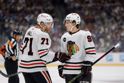 Oct 19, 2023; Denver, Colorado, USA; Chicago Blackhawks left wing Taylor Hall (71) talks with center Connor Bedard (98) in the first period against the Colorado Avalanche at Ball Arena. Mandatory Credit: Isaiah J. Downing-USA TODAY Sports