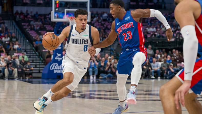 Oct 20, 2023; Dallas, Texas, USA; Dallas Mavericks guard Josh Green (8) moves the ball past Detroit Pistons guard Jaden Ivey (23) during the first quarter at the American Airlines Center. Mandatory Credit: Jerome Miron-USA TODAY Sports