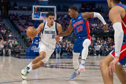 Oct 20, 2023; Dallas, Texas, USA; Dallas Mavericks guard Josh Green (8) moves the ball past Detroit Pistons guard Jaden Ivey (23) during the first quarter at the American Airlines Center. Mandatory Credit: Jerome Miron-USA TODAY Sports