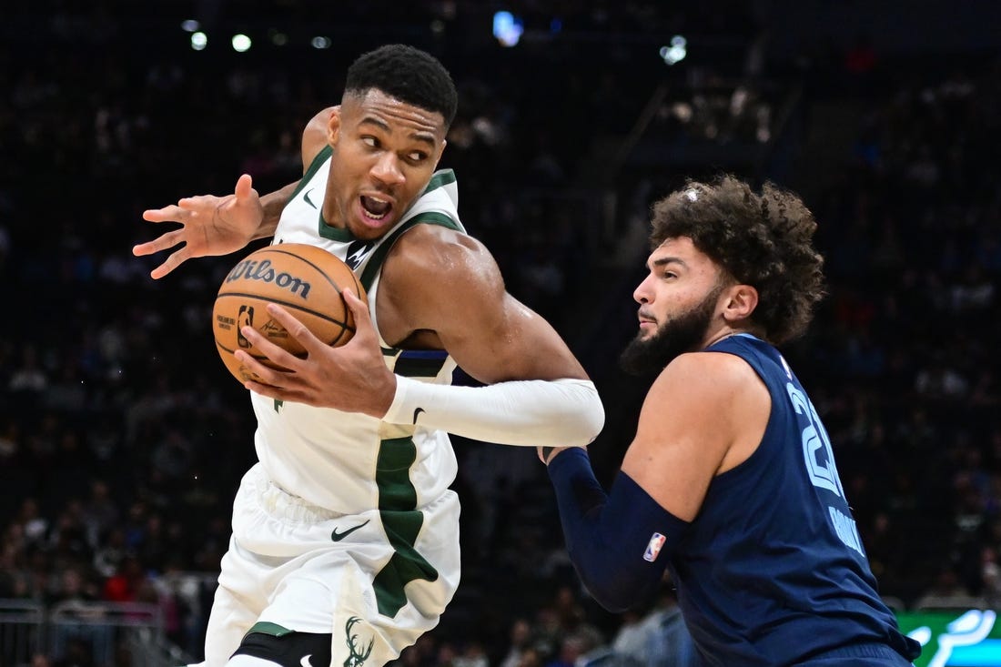 Oct 20, 2023; Milwaukee, Wisconsin, USA; Milwaukee Bucks forward Giannis Antetokounmpo (34) drives for the basket against Memphis Grizzlies center David Roddy (21) in the third quarter at Fiserv Forum. Mandatory Credit: Benny Sieu-USA TODAY Sports