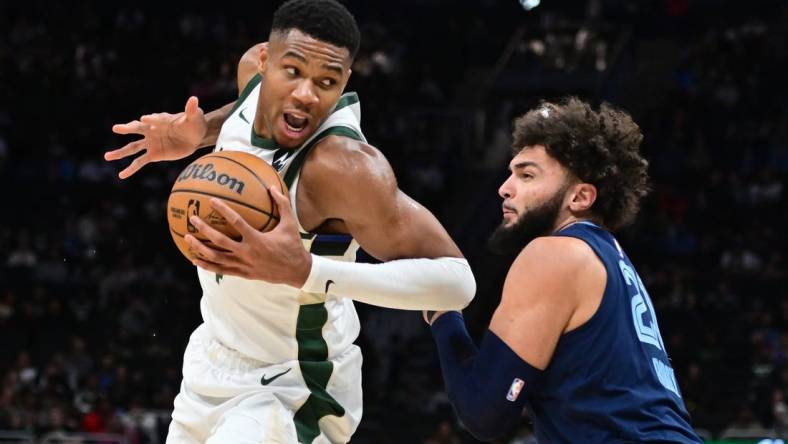 Oct 20, 2023; Milwaukee, Wisconsin, USA; Milwaukee Bucks forward Giannis Antetokounmpo (34) drives for the basket against Memphis Grizzlies center David Roddy (21) in the third quarter at Fiserv Forum. Mandatory Credit: Benny Sieu-USA TODAY Sports