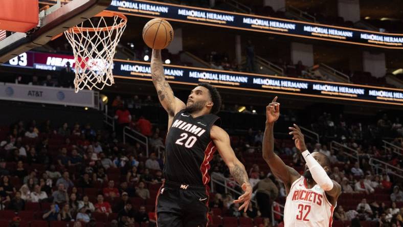 Oct 20, 2023; Houston, Texas, USA; Miami Heat forward Justin Champagnie (20) dunks as Houston Rockets forward Jeff Green (32) defends in the fourth quarter at Toyota Center. Mandatory Credit: Thomas Shea-USA TODAY Sports