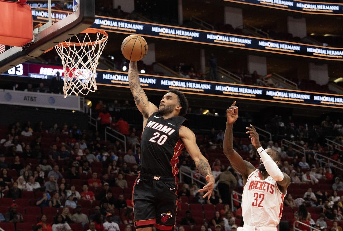 Oct 20, 2023; Houston, Texas, USA; Miami Heat forward Justin Champagnie (20) dunks as Houston Rockets forward Jeff Green (32) defends in the fourth quarter at Toyota Center. Mandatory Credit: Thomas Shea-USA TODAY Sports