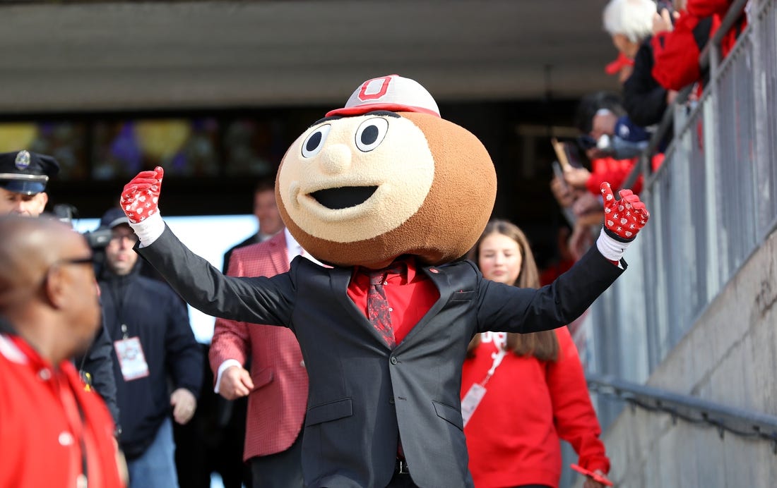 Oct 21, 2023; Columbus, Ohio, USA;  Ohio State Buckeyes mascot Brutus Buckeye greets fans before a game against the Penn State Nittany Lions at Ohio Stadium. Mandatory Credit: Joseph Maiorana-USA TODAY Sports