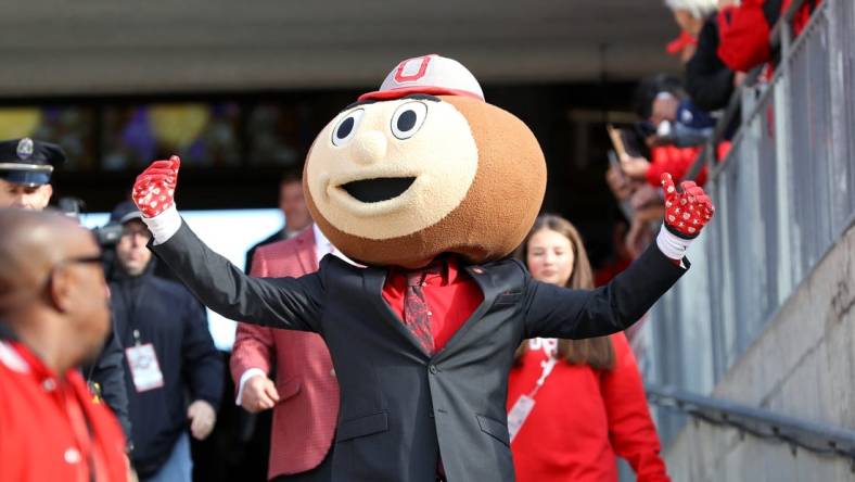 Oct 21, 2023; Columbus, Ohio, USA;  Ohio State Buckeyes mascot Brutus Buckeye greets fans before a game against the Penn State Nittany Lions at Ohio Stadium. Mandatory Credit: Joseph Maiorana-USA TODAY Sports