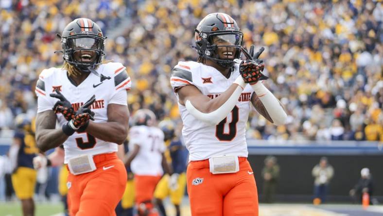 Oct 21, 2023; Morgantown, West Virginia, USA; Oklahoma State Cowboys running back Ollie Gordon II (0) celebrates after running for a touchdown during the first quarter against the West Virginia Mountaineers at Mountaineer Field at Milan Puskar Stadium. Mandatory Credit: Ben Queen-USA TODAY Sports