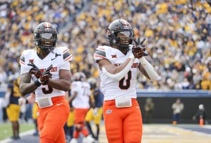 Oct 21, 2023; Morgantown, West Virginia, USA; Oklahoma State Cowboys running back Ollie Gordon II (0) celebrates after running for a touchdown during the first quarter against the West Virginia Mountaineers at Mountaineer Field at Milan Puskar Stadium. Mandatory Credit: Ben Queen-USA TODAY Sports