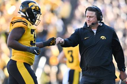 Oct 21, 2023; Iowa City, Iowa, USA; Iowa Hawkeyes assistant coach Brian Ferentz reacts with linebacker Jay Higgins (34) as he returns to the sideline during the second quarter against the Minnesota Golden Gophers at Kinnick Stadium. Mandatory Credit: Jeffrey Becker-USA TODAY Sports