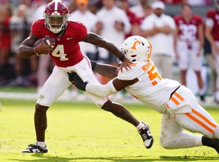 Oct 21, 2023; Tuscaloosa, Alabama, USA; Alabama Crimson Tide quarterback Jalen Milroe (4) gets sacked behind the line of scrimmage by Tennessee Volunteers defensive lineman Omarr Norman-Lott (55) during the first half at Bryant-Denny Stadium. Mandatory Credit: John David Mercer-USA TODAY Sports