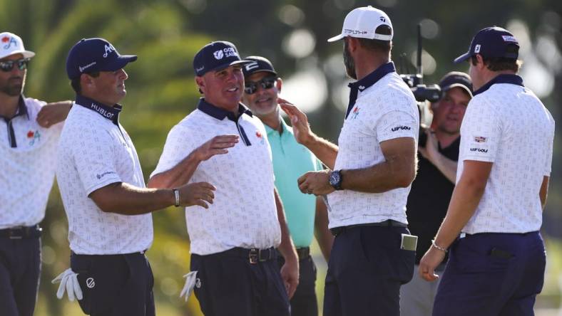 Oct 21, 2023; Doral, Florida, USA; Dustin Johnson celebrates with teammates Patrick Reed, Pat Perez and Peter Uihlein during the second round of the LIV Golf Miami golf tournament at Trump National Doral. Mandatory Credit: Sam Navarro-USA TODAY Sports