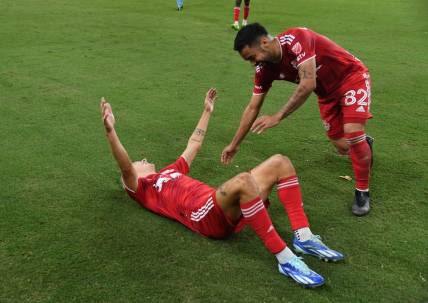 Oct 21, 2023; Nashville, Tennessee, USA; New York Red Bulls defender John Tolkin (47) celebrates with midfielder Luquinhas (82) after Tolkin   s goal in extra time against the Nashville SCat Geodis Park. Mandatory Credit: Christopher Hanewinckel-USA TODAY Sports