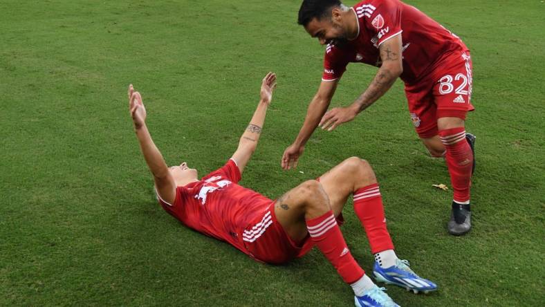 Oct 21, 2023; Nashville, Tennessee, USA; New York Red Bulls defender John Tolkin (47) celebrates with midfielder Luquinhas (82) after Tolkin   s goal in extra time against the Nashville SCat Geodis Park. Mandatory Credit: Christopher Hanewinckel-USA TODAY Sports