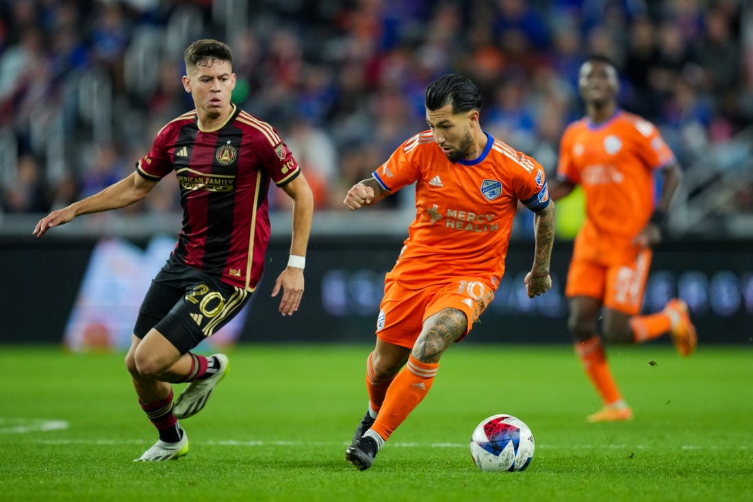 Oct 21, 2023; Cincinnati, Ohio, USA;  FC Cincinnati midfielder Luciano Acosta (10) dribbles the ball against Atlanta United FC midfielder Matheus Rossetto (20) in the second half at TQL Stadium. Mandatory Credit: Aaron Doster-USA TODAY Sports