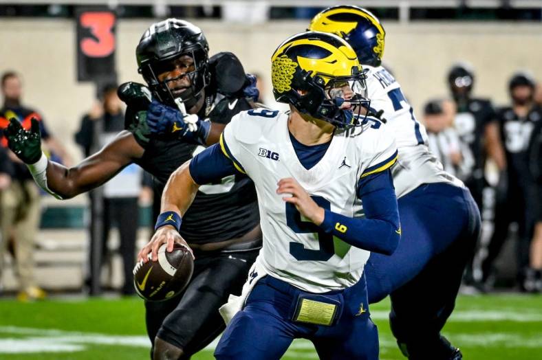 Michigan's J.J. McCarthy looks to throw against Michigan State during the first quarter on Saturday, Oct. 21, 2023, at Spartan Stadium in East Lansing.