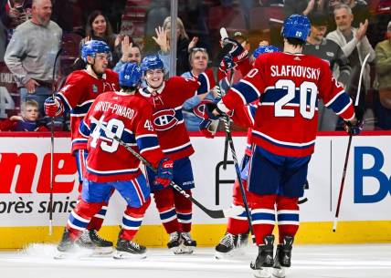 Oct 21, 2023; Montreal, Quebec, CAN; Montreal Canadiens right wing Cole Caufield (22) celebrates his winning goal against the Washington Capitals with his teammates during overtime at Bell Centre. Mandatory Credit: David Kirouac-USA TODAY Sports