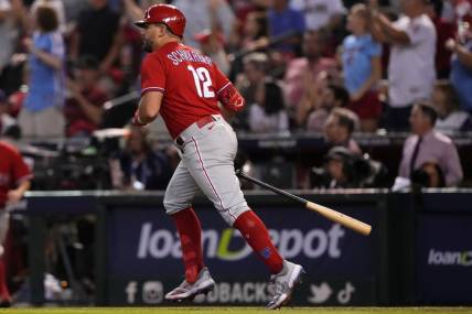 Oct 21, 2023; Phoenix, Arizona, USA; Philadelphia Phillies left fielder Kyle Schwarber (12) hits a home run against the Arizona Diamondbacks in the sixth inning during game five of the NLCS for the 2023 MLB playoffs at Chase Field. Mandatory Credit: Joe Camporeale-USA TODAY Sports