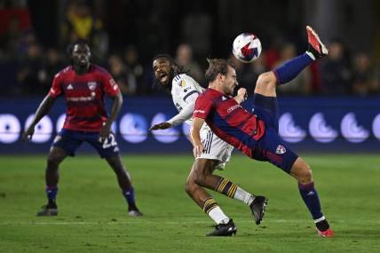 Oct 21, 2023; Carson, California, USA; FC Dallas midfielder Paxton Pomykal (19) plays the ball against Los Angeles Galaxy forward Raheem Edwards (44) during the second half at Dignity Health Sports Park. Mandatory Credit: Kelvin Kuo-USA TODAY Sports