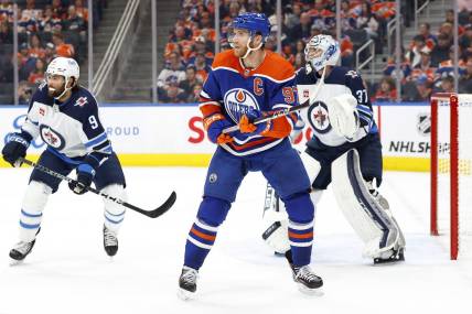 Oct 21, 2023; Edmonton, Alberta, CAN; Edmonton Oilers forward Connor McDavid (97) looks for a pass in front of Winnipeg Jets goaltender Connor Hellebuyck (37) during the first period at Rogers Place. Mandatory Credit: Perry Nelson-USA TODAY Sports
