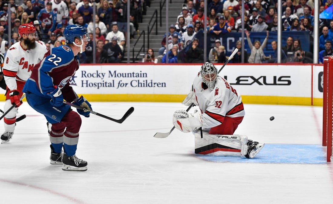 Oct 21, 2023; Denver, Colorado, USA; Colorado Avalanche center Fredrik Olofsson (22) takes a shot on Carolina Hurricanes goaltender Pyotr Kochetkov (52) for a goal in the second period at Ball Arena. Mandatory Credit: John Leyba-USA TODAY Sports