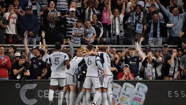 Oct 21, 2023; Kansas City, Kansas, USA; Sporting Kansas City forward Johnny Russell (7) celebrates with teammates after scoring a goal against Minnesota United during the first half at Children's Mercy Park. Mandatory Credit: Denny Medley-USA TODAY Sports