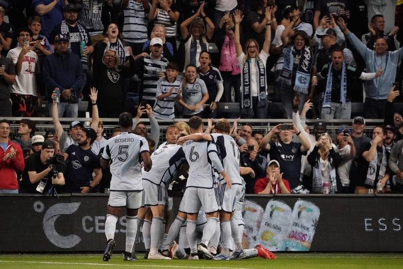 Oct 21, 2023; Kansas City, Kansas, USA; Sporting Kansas City forward Johnny Russell (7) celebrates with teammates after scoring a goal against Minnesota United during the first half at Children's Mercy Park. Mandatory Credit: Denny Medley-USA TODAY Sports