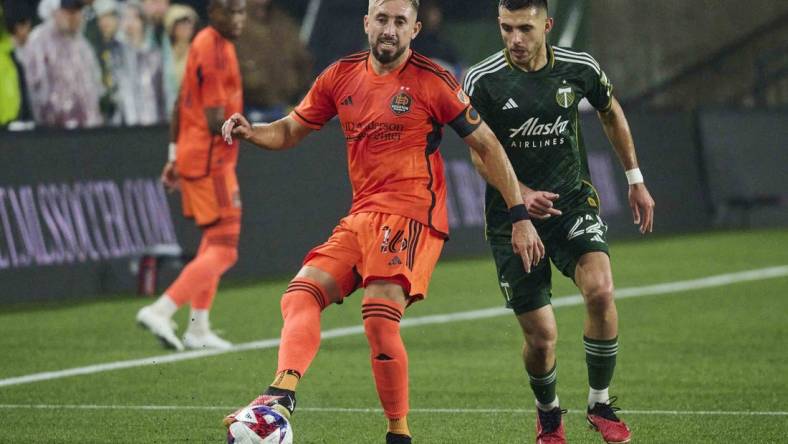 Oct 21, 2023; Portland, Oregon, USA; Houston Dynamo midfielder Hector Herrera (16) passes the ball against Portland Timbers midfielder Cristhian Paredes (22) during the first half at Providence Park. Mandatory Credit: Troy Wayrynen-USA TODAY Sports