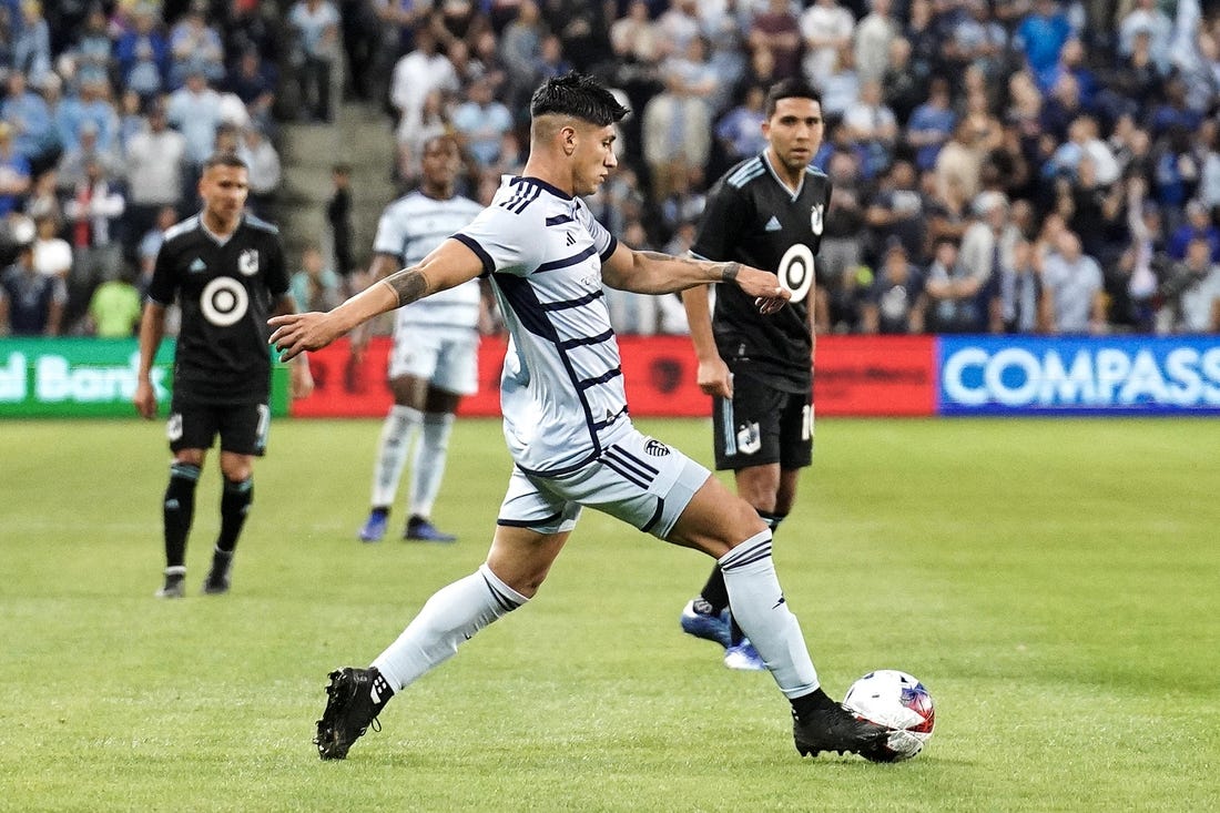 Oct 21, 2023; Kansas City, Kansas, USA; Sporting Kansas City forward Alan Pulido (9) dribbles the ball against Minnesota United during the second half at Children's Mercy Park. Mandatory Credit: Denny Medley-USA TODAY Sports