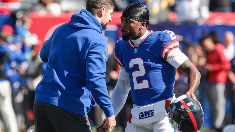 Oct 22, 2023; East Rutherford, New Jersey, USA; New York Giants quarterback Daniel Jones (left) talks with quarterback Tyrod Taylor (2) before the game against the Washington Commanders at MetLife Stadium. Mandatory Credit: Vincent Carchietta-USA TODAY Sports