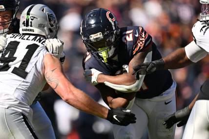 Oct 22, 2023; Chicago, Illinois, USA;  Chicago Bears running back D'Onta Foreman (21) fights through a tackle attempt from Las Vegas Raiders linebacker Robert Spillane (41) to score a touchdown in the second quarter at Soldier Field. Mandatory Credit: Jamie Sabau-USA TODAY Sports