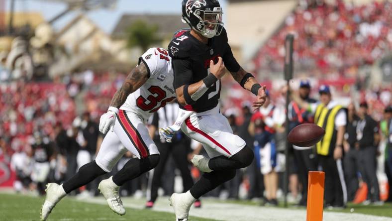 Oct 22, 2023; Tampa, Florida, USA;  Tampa Bay Buccaneers safety Antoine Winfield Jr. (31) forces a fumble by Atlanta Falcons quarterback Desmond Ridder (9) at the goal line in the fourth quarter at Raymond James Stadium. Mandatory Credit: Nathan Ray Seebeck-USA TODAY Sports