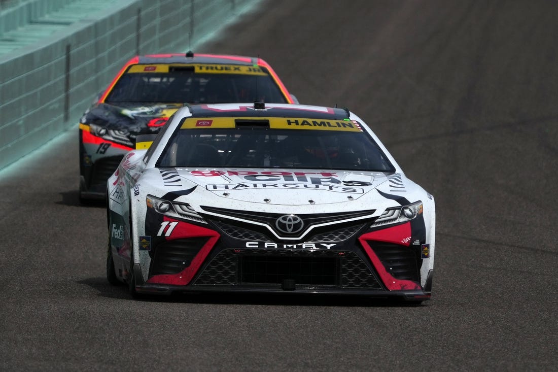 Oct 22, 2023; Homestead, Florida, USA; NASCAR Cup Series driver Denny Hamlin (11) leads NASCAR Cup Series driver Martin Truex Jr (19) during the 4EVER 400 presented by Mobil 1 at Homestead-Miami Speedway. Mandatory Credit: Jasen Vinlove-USA TODAY Sports