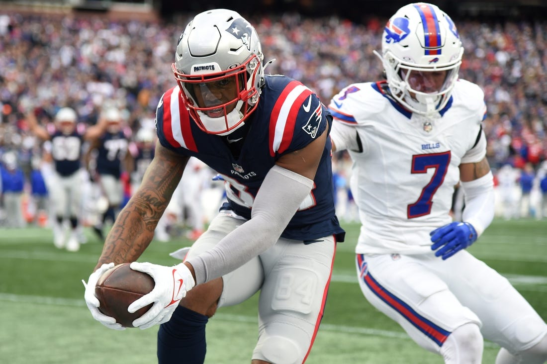 Oct 22, 2023; Foxborough, Massachusetts, USA;  New England Patriots wide receiver Kendrick Bourne (84) scores a touchdown past Buffalo Bills cornerback Taron Johnson (7) during the second half at Gillette Stadium. Mandatory Credit: Bob DeChiara-USA TODAY Sports