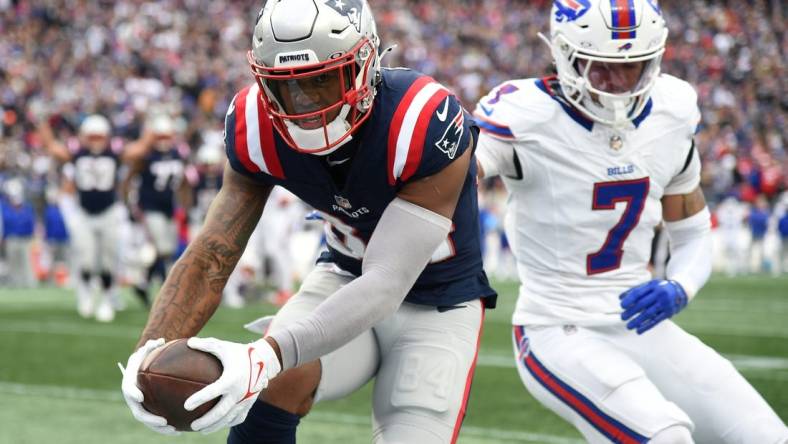 Oct 22, 2023; Foxborough, Massachusetts, USA;  New England Patriots wide receiver Kendrick Bourne (84) scores a touchdown past Buffalo Bills cornerback Taron Johnson (7) during the second half at Gillette Stadium. Mandatory Credit: Bob DeChiara-USA TODAY Sports