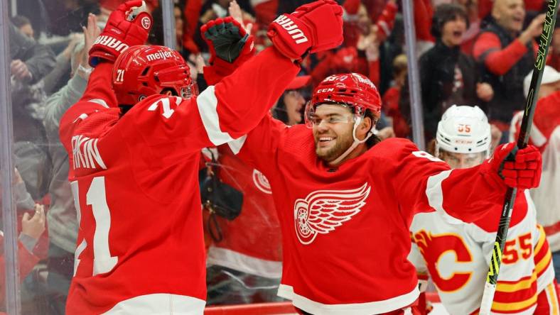 Oct 22, 2023; Detroit, Michigan, USA;  Detroit Red Wings center Dylan Larkin (71) celebrates with right wing Alex DeBrincat (93) after scoring in the second period against the Calgary Flames at Little Caesars Arena. Mandatory Credit: Rick Osentoski-USA TODAY Sports