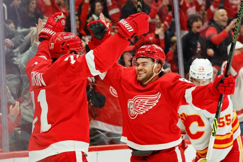 Oct 22, 2023; Detroit, Michigan, USA;  Detroit Red Wings center Dylan Larkin (71) celebrates with right wing Alex DeBrincat (93) after scoring in the second period against the Calgary Flames at Little Caesars Arena. Mandatory Credit: Rick Osentoski-USA TODAY Sports