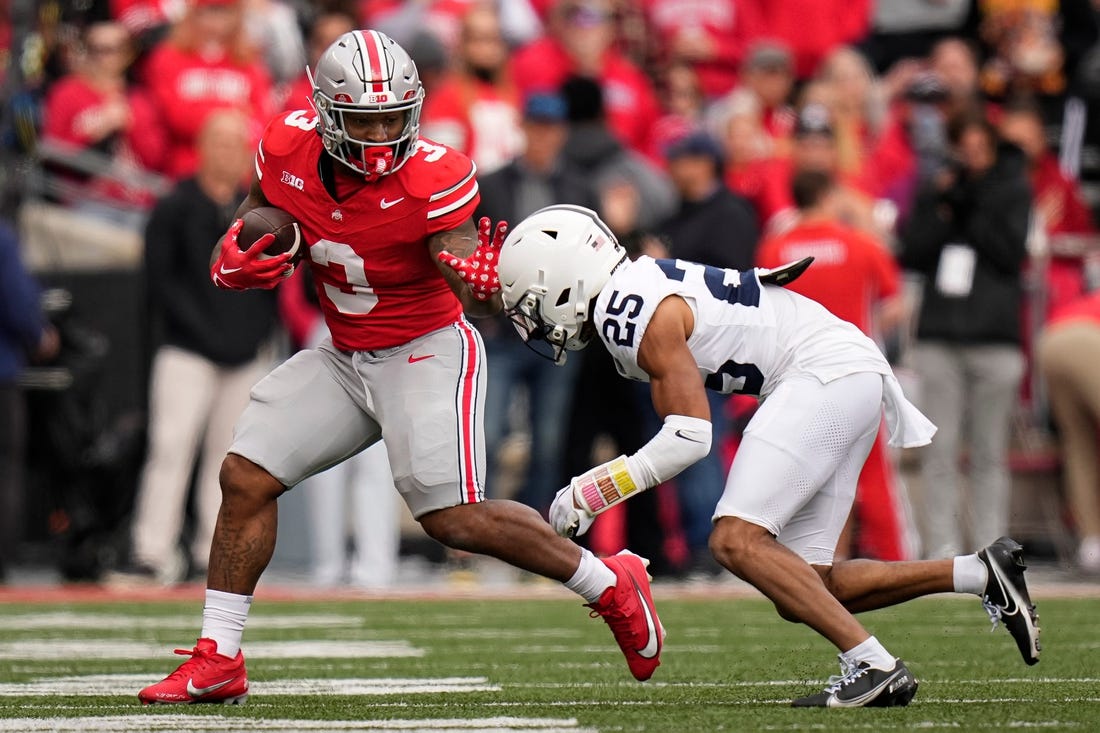 Oct 21, 2023; Columbus, Ohio, USA; Ohio State Buckeyes running back Miyan Williams (3) runs past Penn State Nittany Lions running back DK Kency (25) during the NCAA football game at Ohio Stadium.