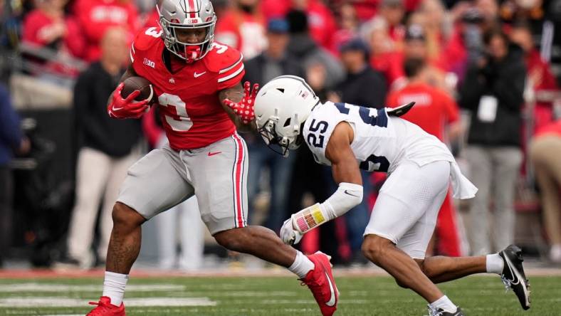 Oct 21, 2023; Columbus, Ohio, USA; Ohio State Buckeyes running back Miyan Williams (3) runs past Penn State Nittany Lions running back DK Kency (25) during the NCAA football game at Ohio Stadium.