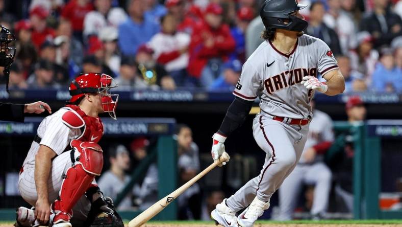 Oct 23, 2023; Philadelphia, Pennsylvania, USA; Arizona Diamondbacks center fielder Alek Thomas (5) hits a single during the sixth inning against the Philadelphia Phillies in game six of the NLCS for the 2023 MLB playoffs at Citizens Bank Park. Mandatory Credit: Bill Streicher-USA TODAY Sports