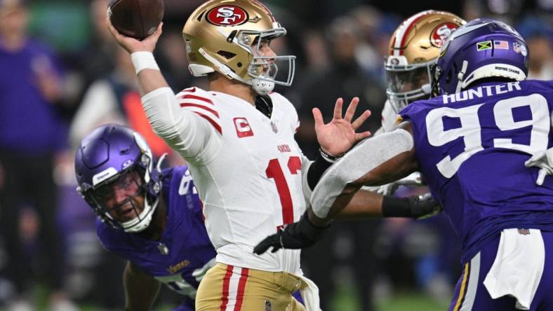 Oct 23, 2023; Minneapolis, Minnesota, USA; San Francisco 49ers quarterback Brock Purdy (13) throws a pass as Minnesota Vikings linebacker Danielle Hunter (99) and linebacker D.J. Wonnum (left) rush in during the first quarter at U.S. Bank Stadium. Mandatory Credit: Jeffrey Becker-USA TODAY Sports