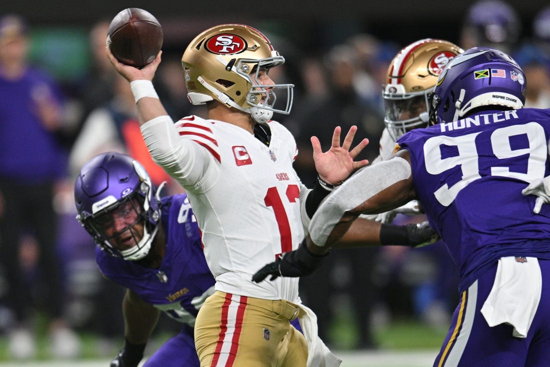 Oct 23, 2023; Minneapolis, Minnesota, USA; San Francisco 49ers quarterback Brock Purdy (13) throws a pass as Minnesota Vikings linebacker Danielle Hunter (99) and linebacker D.J. Wonnum (left) rush in during the first quarter at U.S. Bank Stadium. Mandatory Credit: Jeffrey Becker-USA TODAY Sports