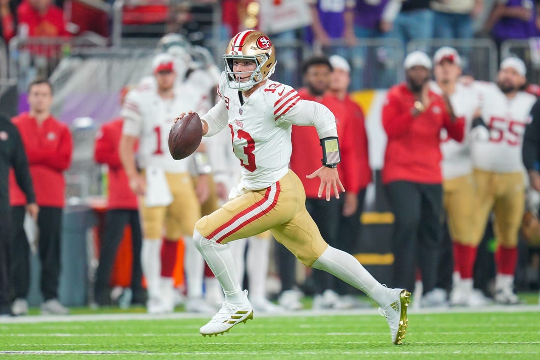 Oct 23, 2023; Minneapolis, Minnesota, USA; San Francisco 49ers quarterback Brock Purdy (13) scrambles against the Minnesota Vikings in the first quarter at U.S. Bank Stadium. Mandatory Credit: Brad Rempel-USA TODAY Sports