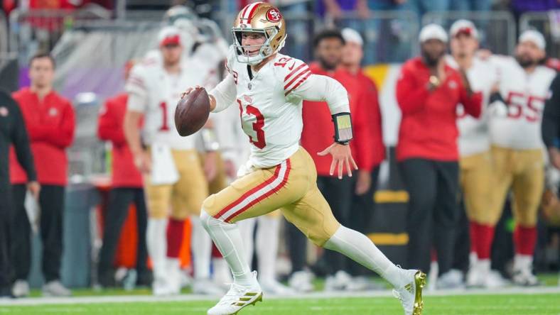 Oct 23, 2023; Minneapolis, Minnesota, USA; San Francisco 49ers quarterback Brock Purdy (13) scrambles against the Minnesota Vikings in the first quarter at U.S. Bank Stadium. Mandatory Credit: Brad Rempel-USA TODAY Sports