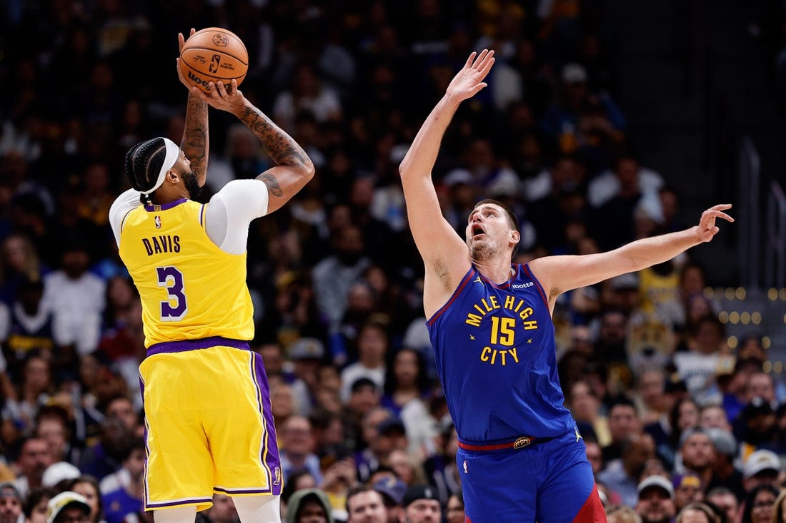 Oct 24, 2023; Denver, Colorado, USA; Los Angeles Lakers forward Anthony Davis (3) attempts a shot as Denver Nuggets center Nikola Jokic (15) guards in the second quarter at Ball Arena. Mandatory Credit: Isaiah J. Downing-USA TODAY Sports