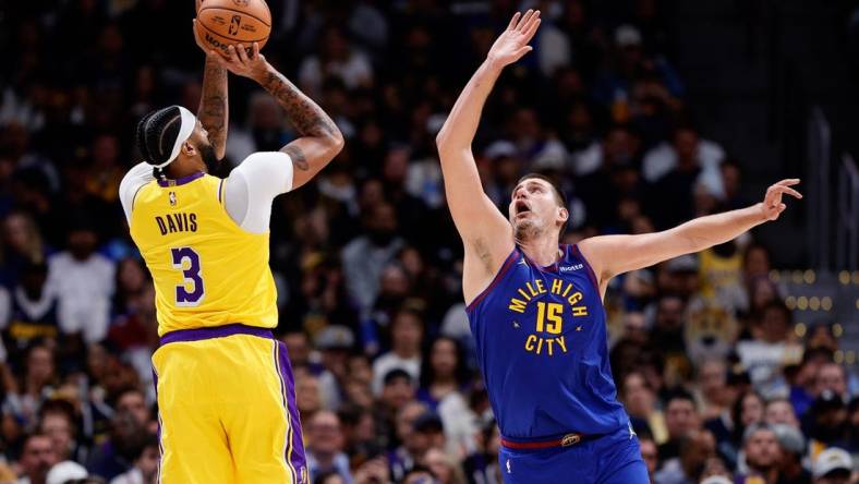 Oct 24, 2023; Denver, Colorado, USA; Los Angeles Lakers forward Anthony Davis (3) attempts a shot as Denver Nuggets center Nikola Jokic (15) guards in the second quarter at Ball Arena. Mandatory Credit: Isaiah J. Downing-USA TODAY Sports