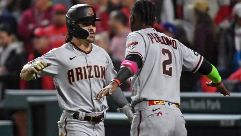 Oct 24, 2023; Philadelphia, Pennsylvania, USA; Arizona Diamondbacks left fielder Corbin Carroll (7) reacts with  shortstop Geraldo Perdomo (2) after scoring a run in the fifth inning during game seven of the NLCS for the 2023 MLB playoffs at Citizens Bank Park. Mandatory Credit: Eric Hartline-USA TODAY Sports