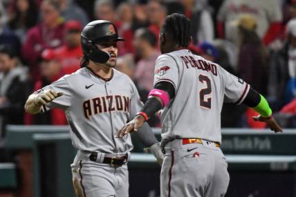 Oct 24, 2023; Philadelphia, Pennsylvania, USA; Arizona Diamondbacks left fielder Corbin Carroll (7) reacts with  shortstop Geraldo Perdomo (2) after scoring a run in the fifth inning during game seven of the NLCS for the 2023 MLB playoffs at Citizens Bank Park. Mandatory Credit: Eric Hartline-USA TODAY Sports