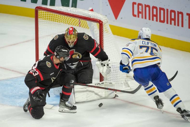 Oct 24, 2023; Ottawa, Ontario, CAN; Ottawa Senators goalie Joonas Korpisalo (70) makes a save on a shot from Buffalo Sabres defenseman Connor Clifton (75) in the third period at the Canadian Tire Centre. Mandatory Credit: Marc DesRosiers-USA TODAY Sports