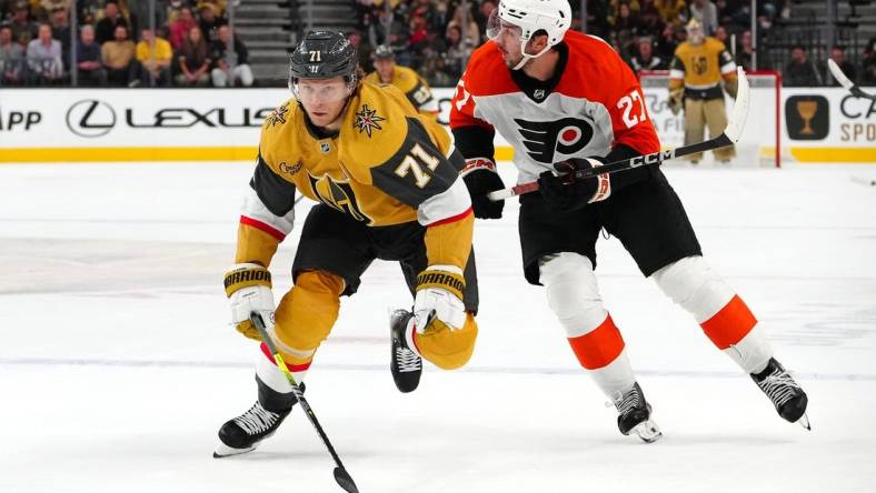 Oct 24, 2023; Las Vegas, Nevada, USA; Vegas Golden Knights center William Karlsson (71) skates ahead of Philadelphia Flyers left wing Noah Cates (27) during the second period at T-Mobile Arena. Mandatory Credit: Stephen R. Sylvanie-USA TODAY Sports