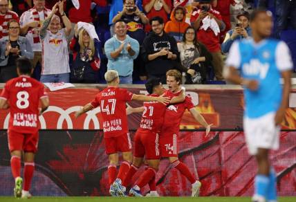 Oct 25, 2023; Harrison, NJ, USA; New York Red Bulls forward Tom Barlow (74) celebrates with midfielder Omir Fernandez (21) after scoring a goal against Charlotte FC during the second half in the Eastern Conference Wild Card match of the 2023 MLS Cup Playoffs at Red Bull Arena. Mandatory Credit: Vincent Carchietta-USA TODAY Sports